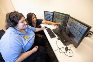 Female dispatcher in front of computers